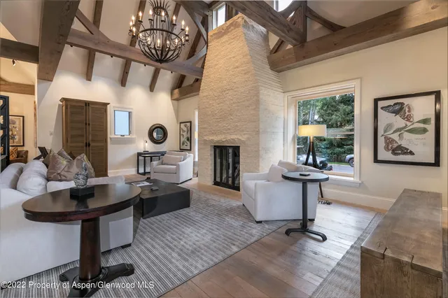a living room with fireplace furniture and a large window
