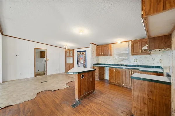 a kitchen with stainless steel appliances granite countertop a sink and wooden cabinets with a granite countertops
