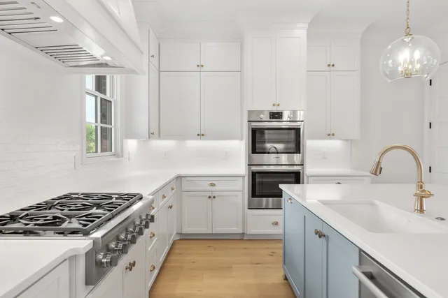 a kitchen with a sink stove and cabinets