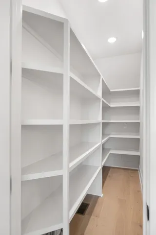 a view of walk in closet with empty racks