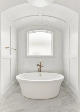 a white bath tub sitting in a bathroom