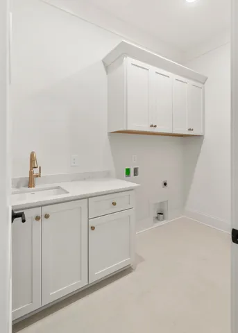 a kitchen with white cabinets and a sink