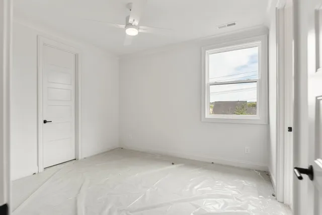 a view of room with window and ceiling fan