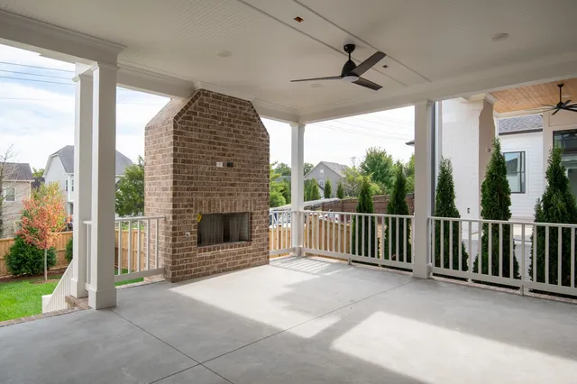 a view of a porch with a floor to ceiling window and a ceiling fan