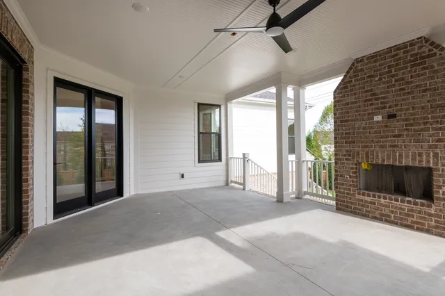 a view of an empty room with a fireplace and a window