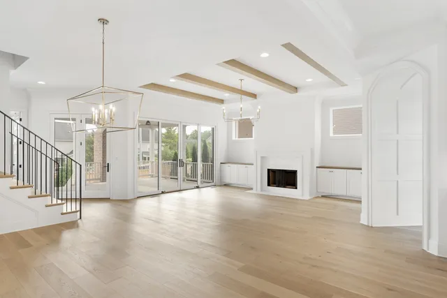 a view interior of a house with wooden floor fireplace and windows