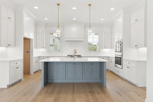 a large kitchen with cabinets and wooden floor
