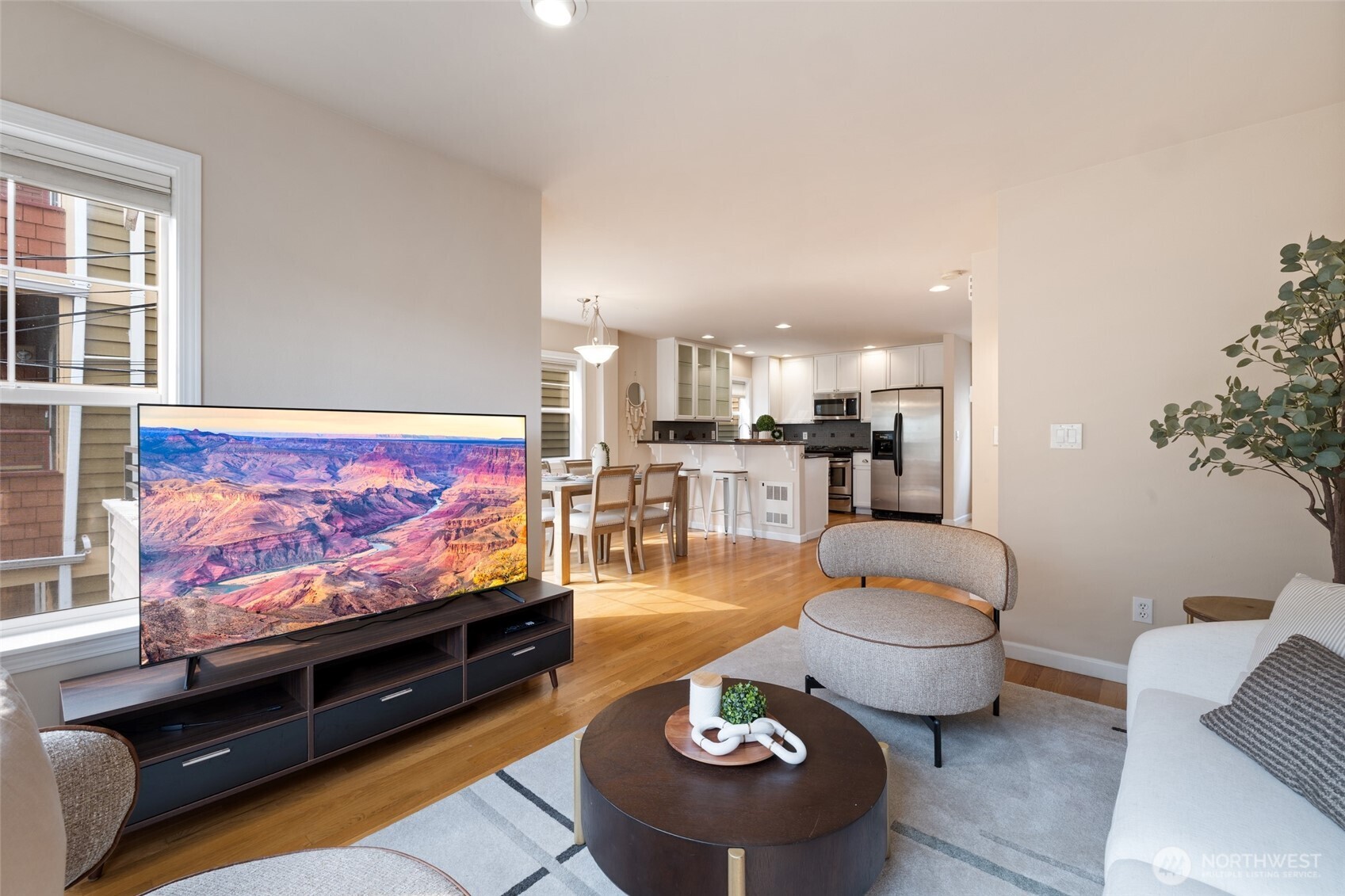 1512 Northwest 57th Street, Unit B Seattle, WA 98107 - Photo 2 of 27 a living room with furniture and a flat screen tv