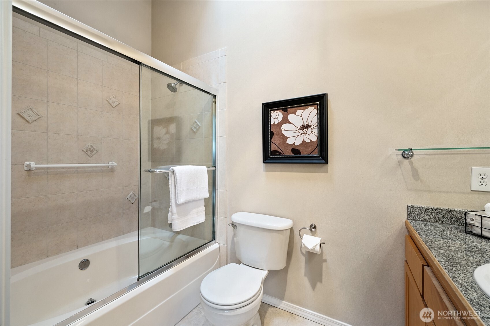 1512 Northwest 57th Street, Unit B Seattle, WA 98107 - Photo 23 of 27 a bathroom with a granite countertop shower a toilet and a sink