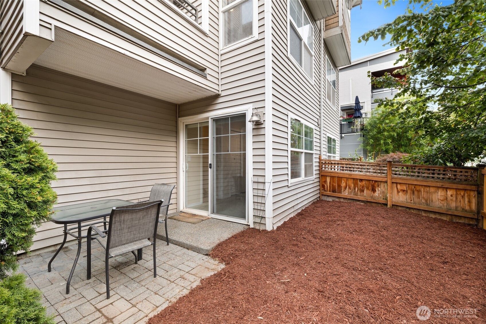 1512 Northwest 57th Street, Unit B Seattle, WA 98107 - Photo 27 of 27 a view of a house with backyard and sitting area
