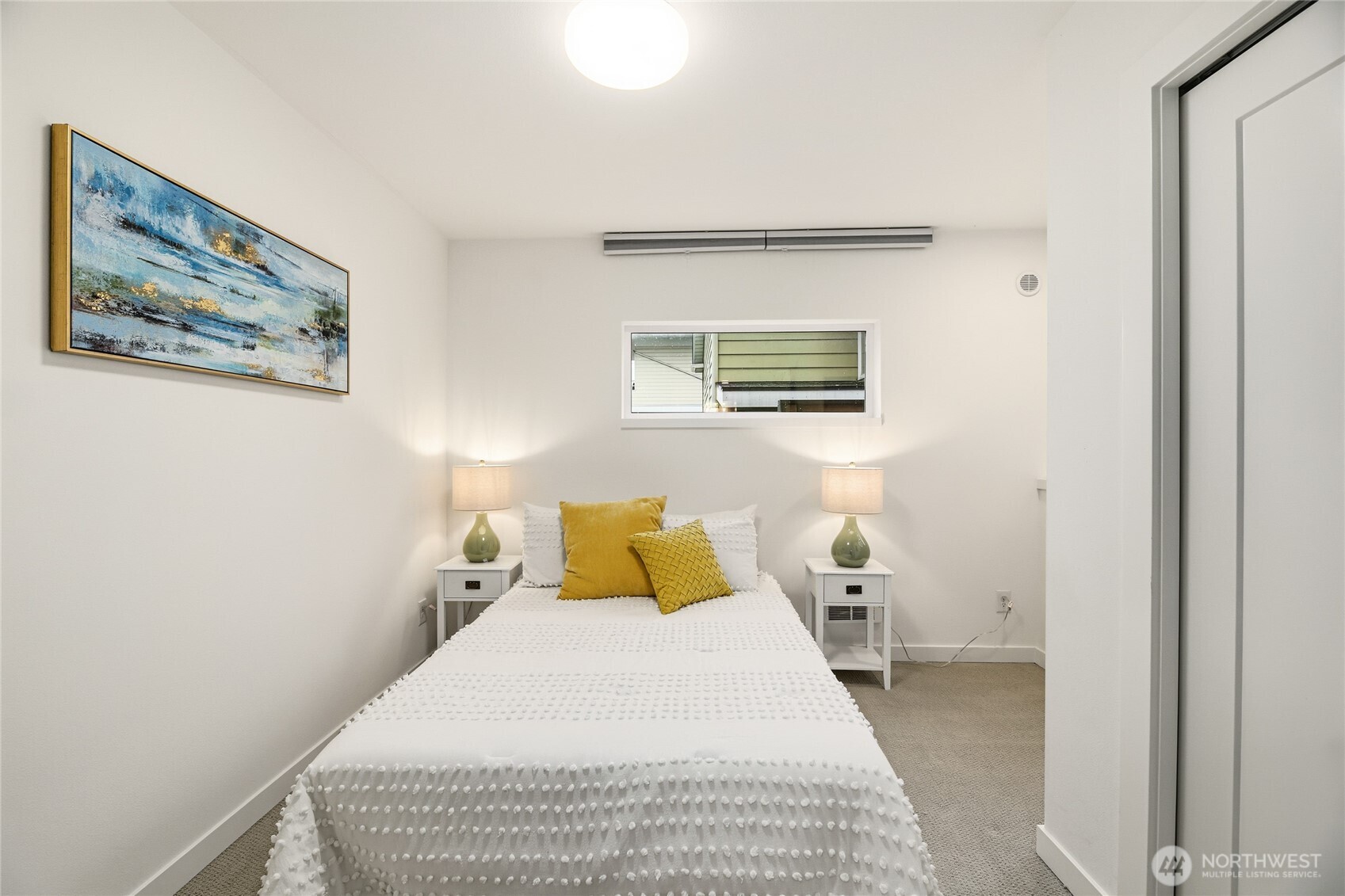 437 Northeast 73rd Street, Unit B Seattle, WA 98115 - Photo 15 of 21 a bedroom with a bed and painting on the wall