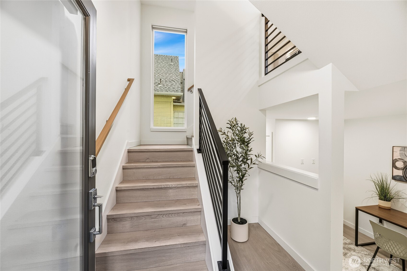 437 Northeast 73rd Street, Unit B Seattle, WA 98115 - Photo 3 of 21 a view of staircase with wooden floor and a potted plant
