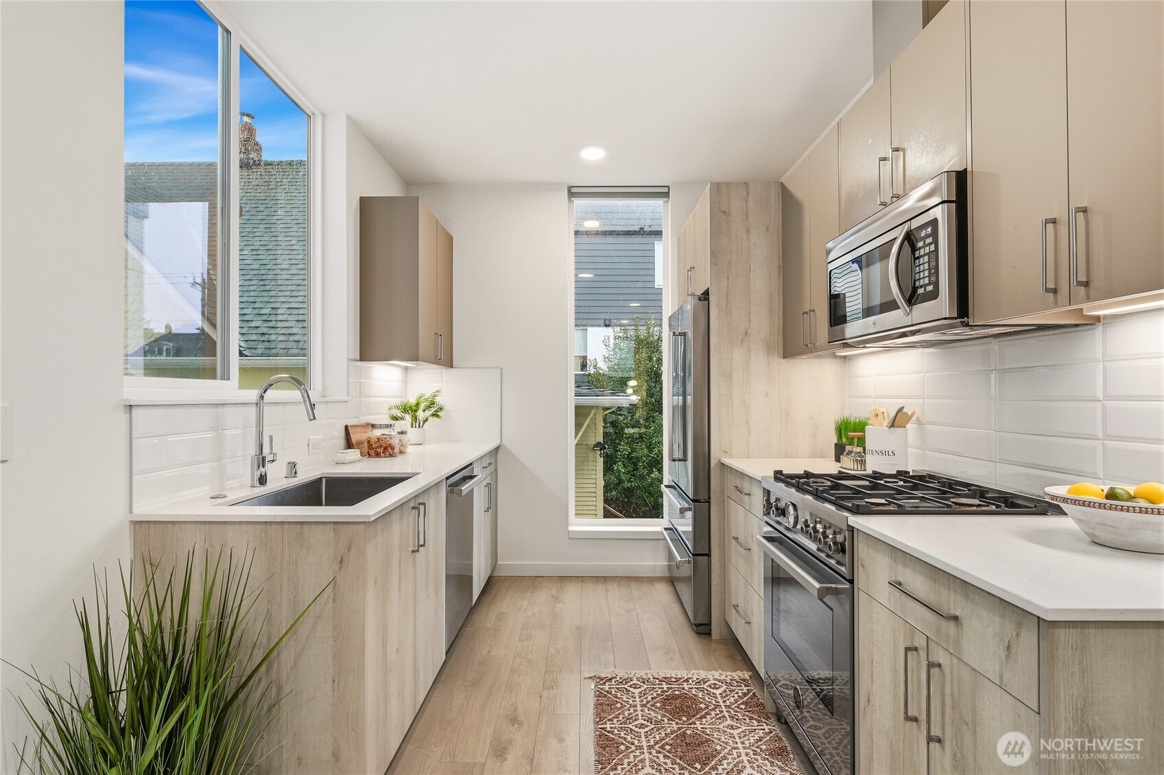 437 Northeast 73rd Street, Unit B Seattle, WA 98115 - Photo 5 of 21 a kitchen with granite countertop a sink stove and cabinets