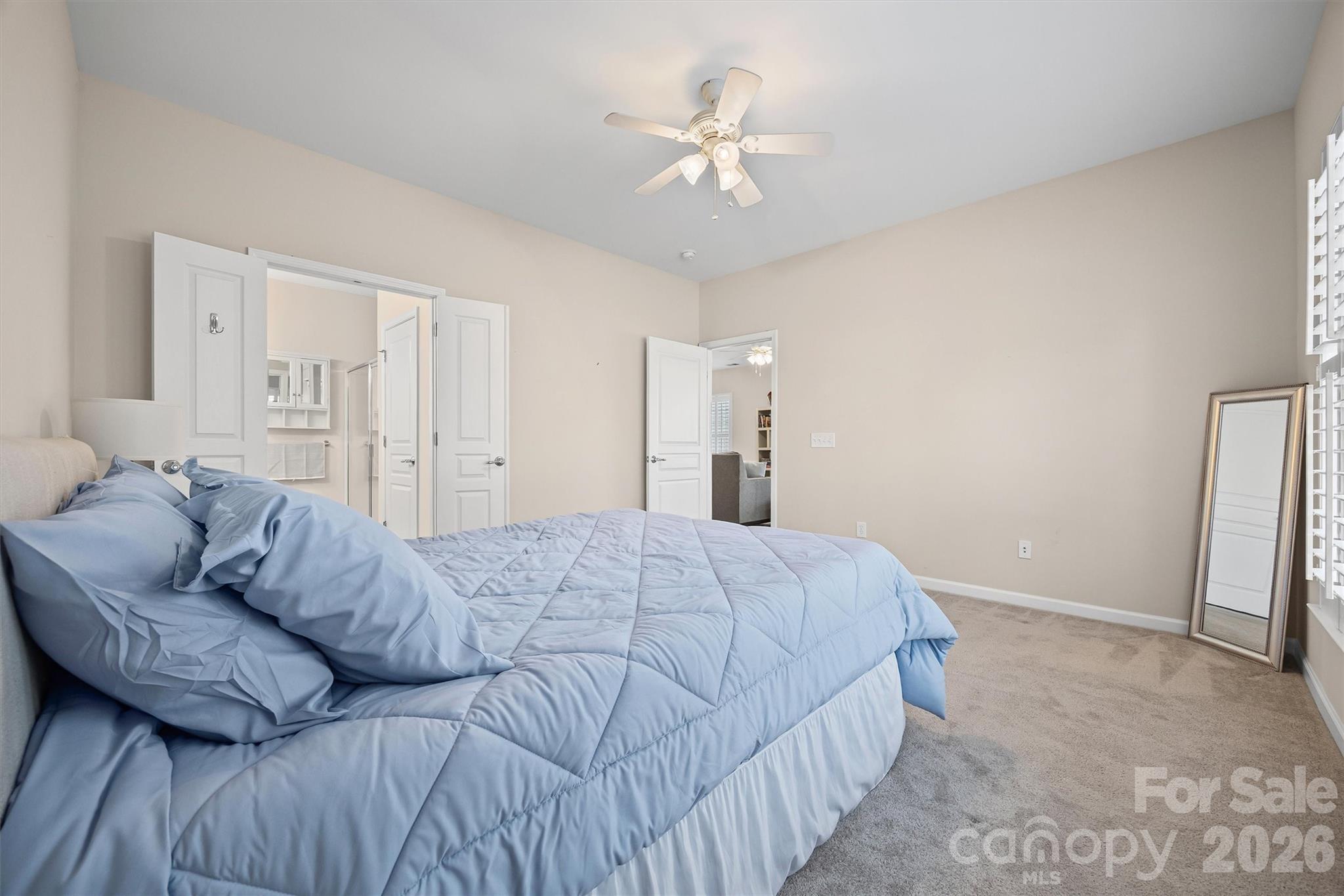 2227 Lilac Lane Fort Mill, SC 29707 - Photo 15 of 42 a spacious bedroom with a bed and a ceiling fan