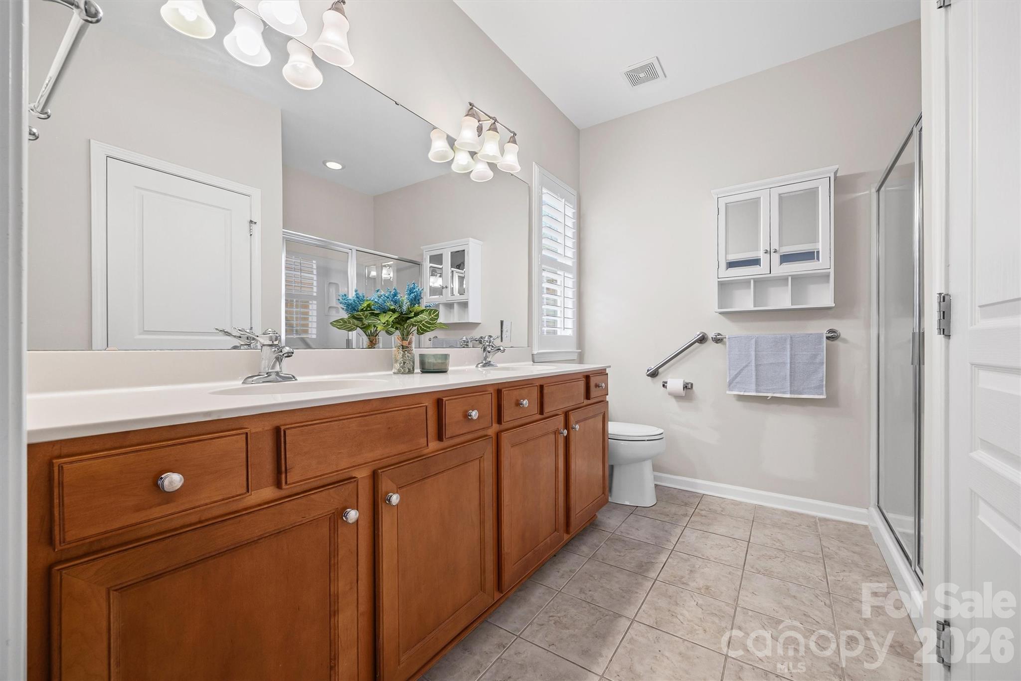 2227 Lilac Lane Fort Mill, SC 29707 - Photo 16 of 42 a spacious bathroom with a double vanity sink mirror and toilet