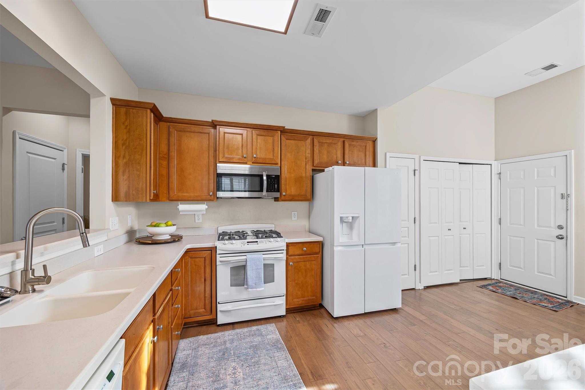 2227 Lilac Lane Fort Mill, SC 29707 - Photo 5 of 42 a kitchen with stainless steel appliances granite countertop a refrigerator a sink dishwasher a stove with wooden cabinets and a stove