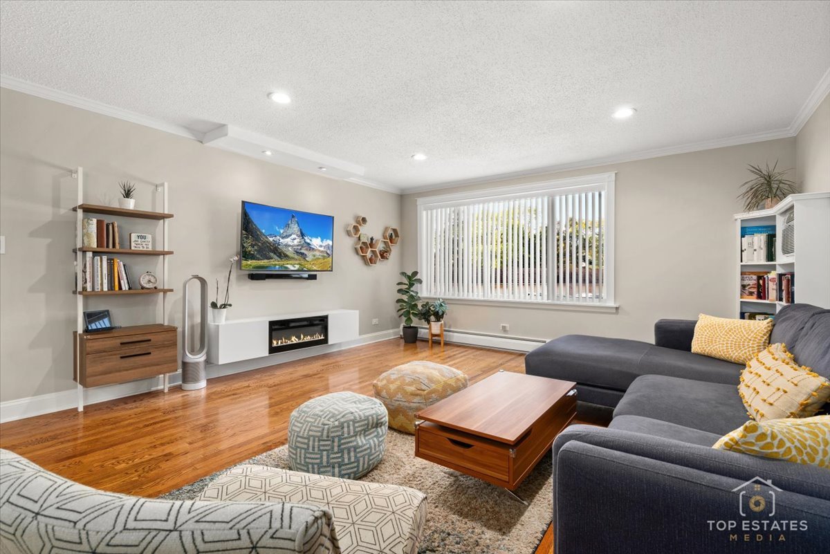 1227 South Old Wilke Road, Unit 201 Rolling Meadows, IL 60005 - Photo 11 of 40 a living room with furniture flat screen tv and a fireplace