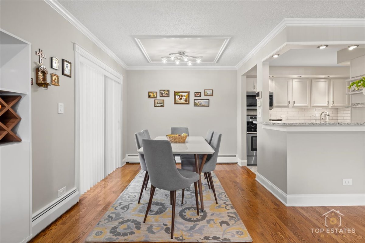 1227 South Old Wilke Road, Unit 201 Rolling Meadows, IL 60005 - Photo 15 of 40 a view of a dining room with furniture and wooden floor