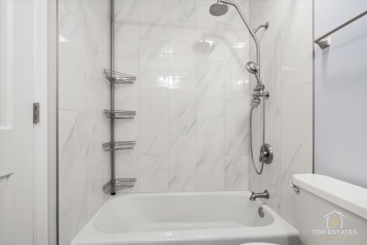 1227 South Old Wilke Road, Unit 201 Rolling Meadows, IL 60005 - Photo 22 of 40 a bathroom with a bathtub a toilet and a shower