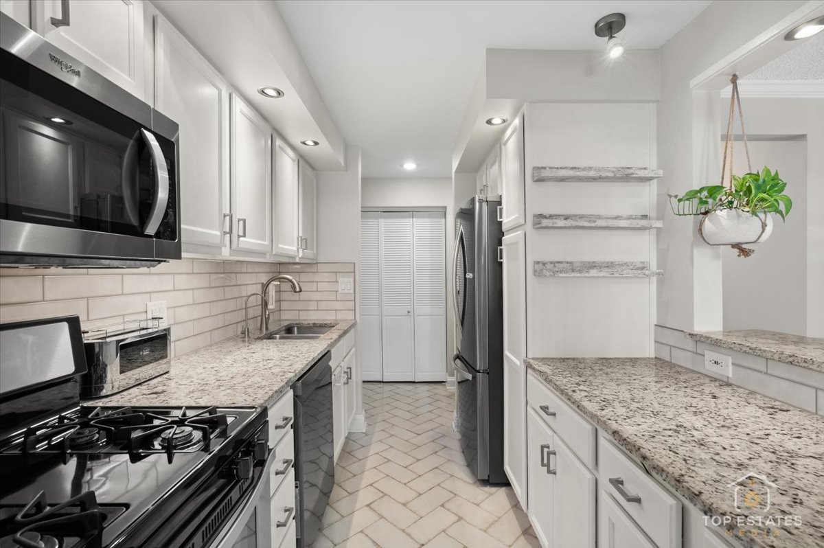 1227 South Old Wilke Road, Unit 201 Rolling Meadows, IL 60005 - Photo 4 of 40 a kitchen with stainless steel appliances granite countertop a refrigerator a stove and a sink