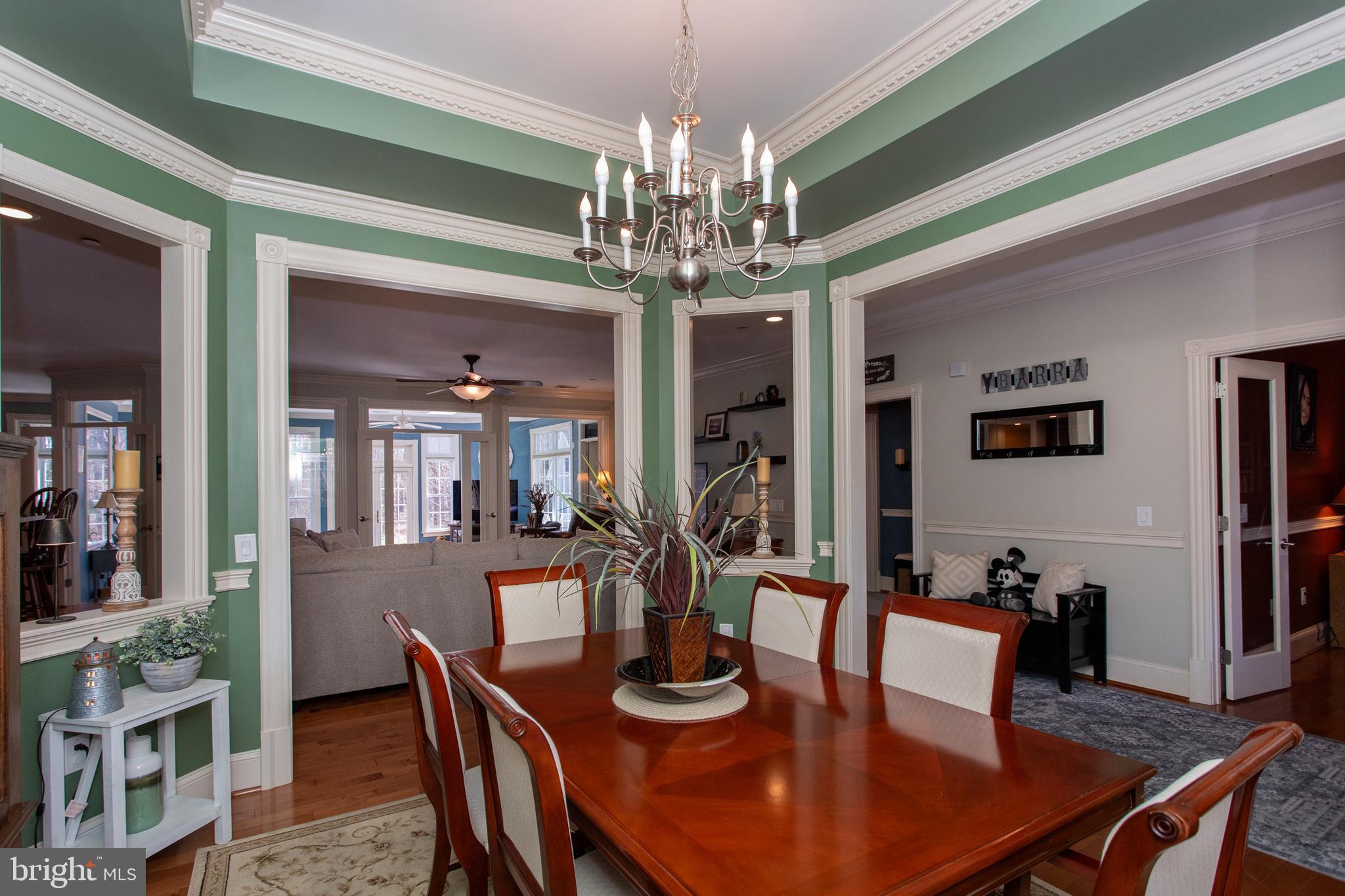 6901 Accokeek Road Brandywine, MD 20613 - Photo 11 of 82 a view of a dining room with furniture a chandelier and wooden floor