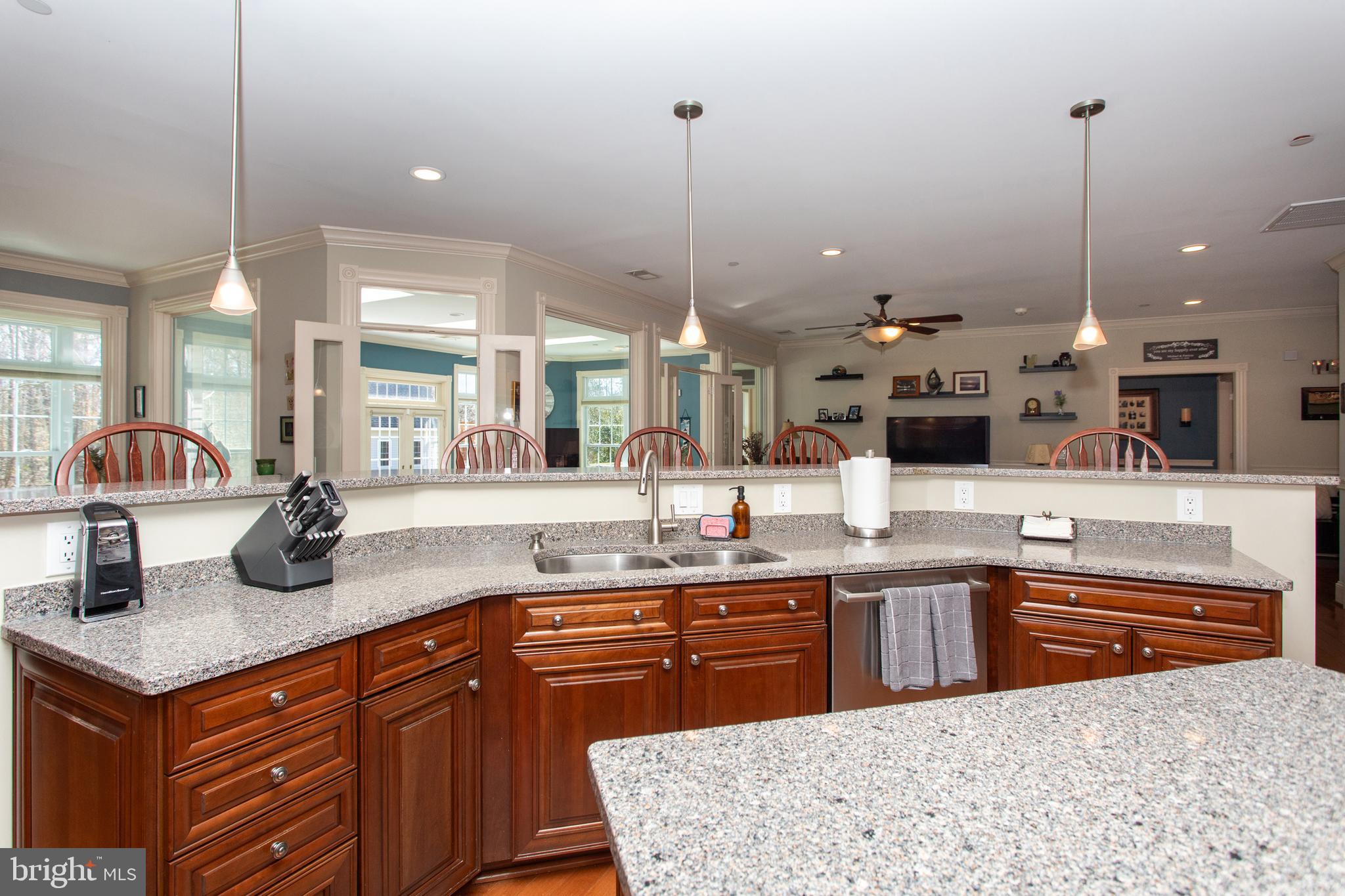 6901 Accokeek Road Brandywine, MD 20613 - Photo 23 of 82 a kitchen with kitchen island granite countertop a sink a counter top space and cabinets