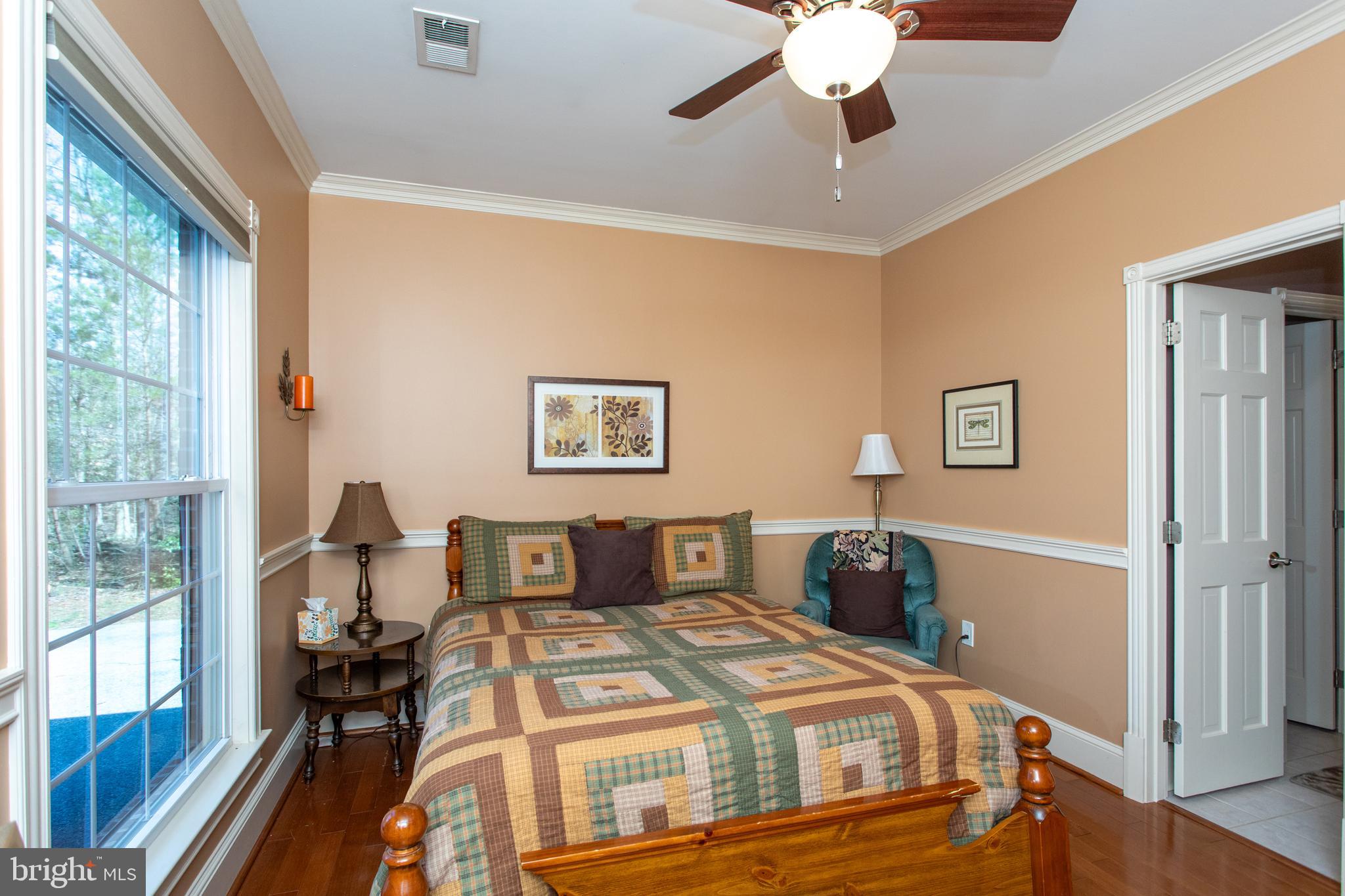 6901 Accokeek Road Brandywine, MD 20613 - Photo 44 of 82 a bedroom with a bed and wooden floor