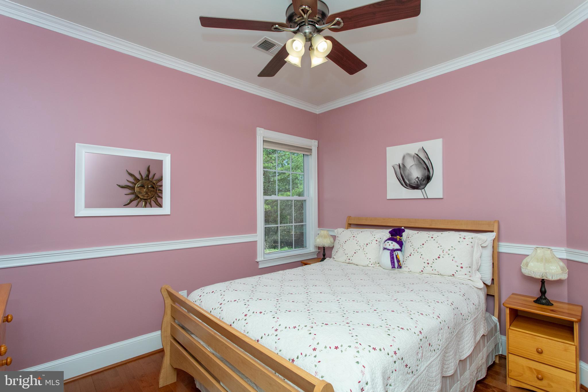 6901 Accokeek Road Brandywine, MD 20613 - Photo 49 of 82 a bedroom with a bed and a chandelier