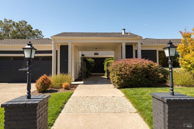 a front view of a house with garden