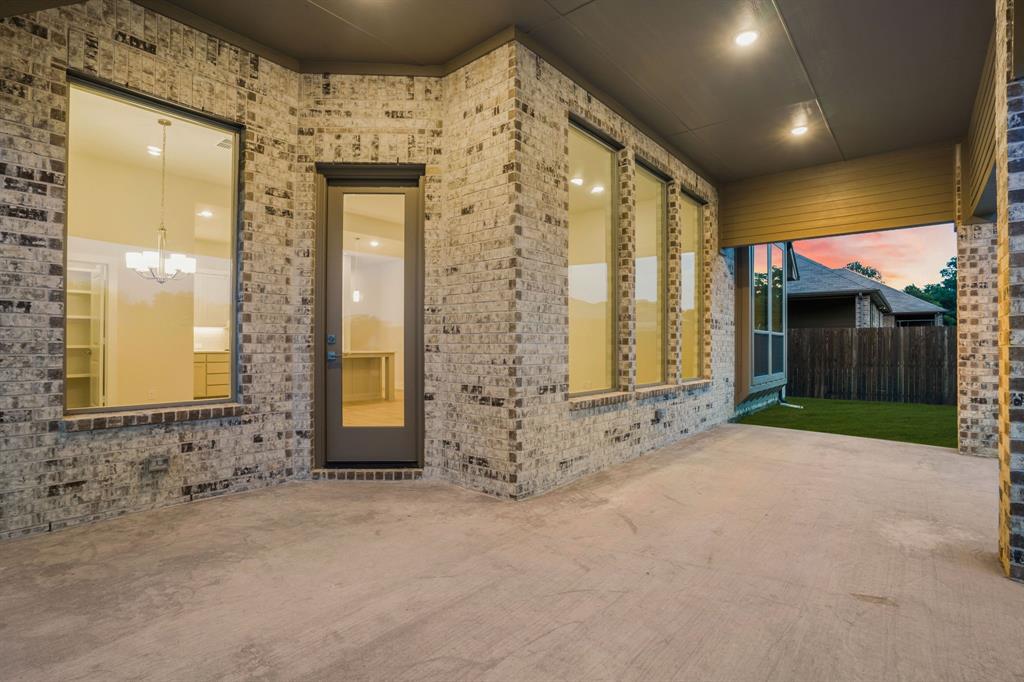 139 Lakeview Circle Pilot Point, TX 76258 - Photo 12 of 19 Property entrance featuring a patio, brick siding, and fence
