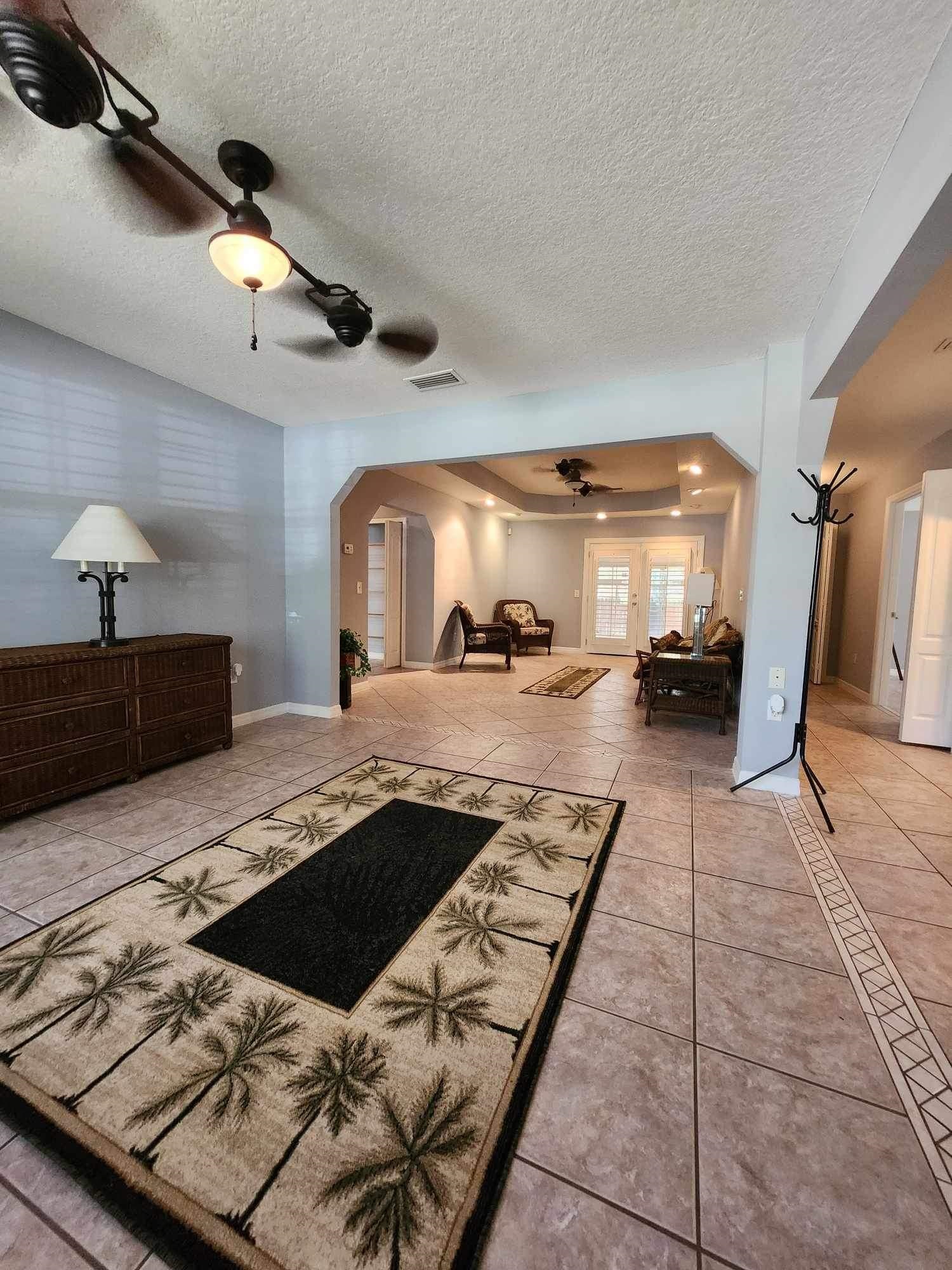 118 Martin Road St. Augustine, FL 32086 - Photo 3 of 34 a living room with hard wood flooring and a rug