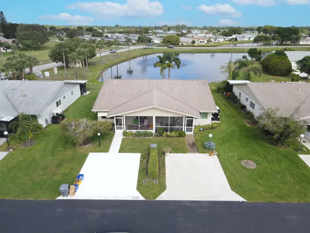 an aerial view of a house with a yard