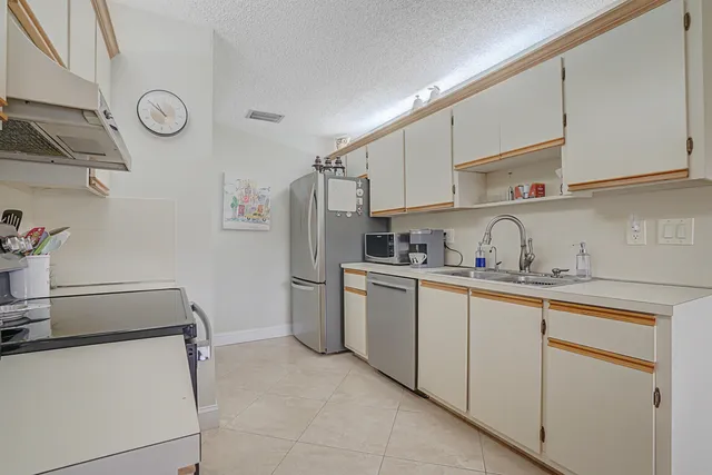 a kitchen with stainless steel appliances granite countertop a sink and cabinets