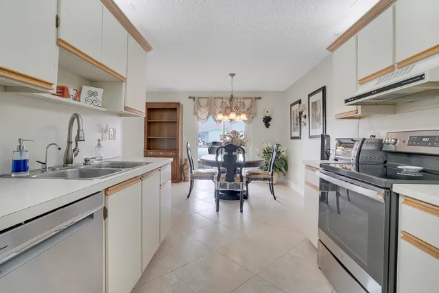a kitchen with stainless steel appliances a sink stove and cabinets