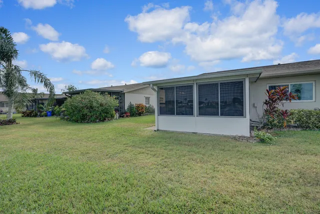 a view of an house with backyard space and garden
