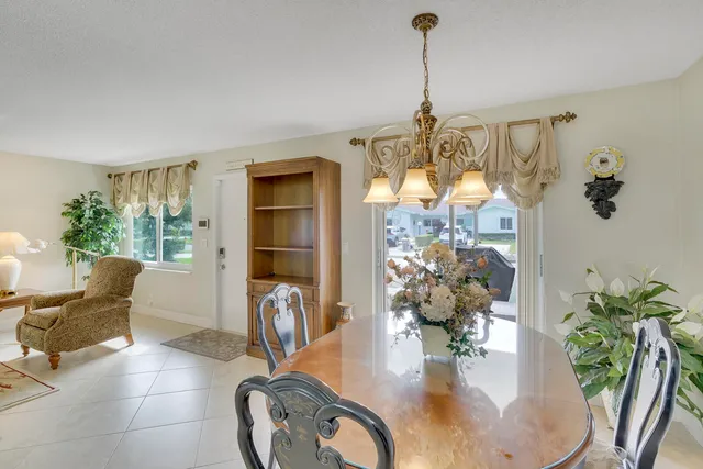 a dining room with furniture and a chandelier
