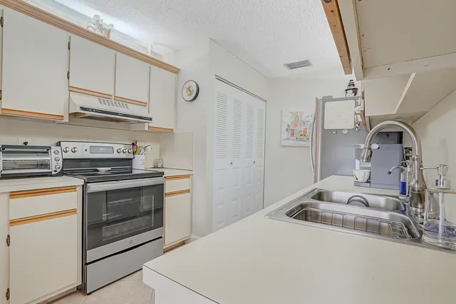 a kitchen with stainless steel appliances granite countertop a sink and cabinets