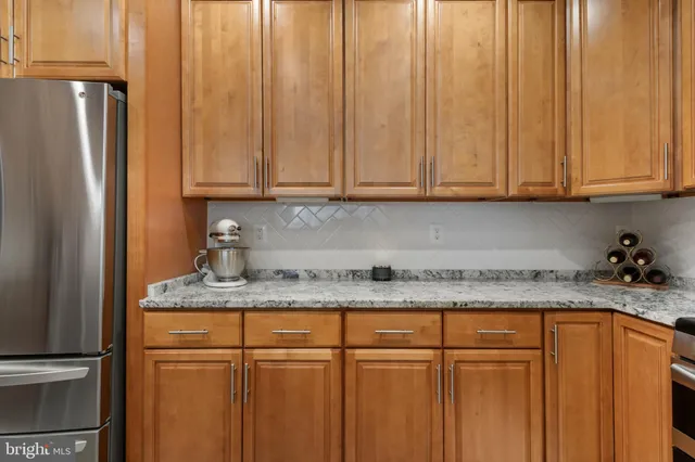 a kitchen with granite countertop stainless steel appliances sink and cabinets