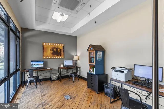 a view of a patio with table and chairs floor to ceiling window and plants