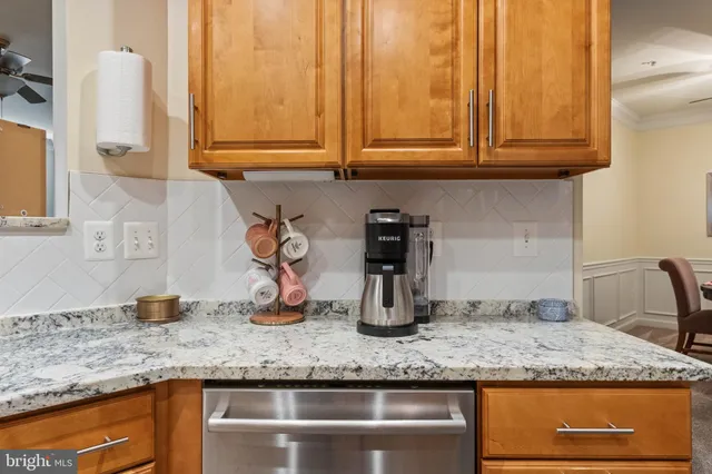 a kitchen with granite countertop stainless steel appliances sink and cabinets