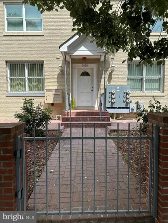 a front view of a house with outdoor seating