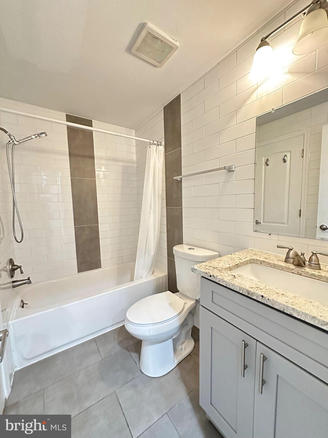 1626 R Street Southeast, Unit 1 Washington, DC 20020 - Photo 14 of 17 a bathroom with a granite countertop sink toilet and shower