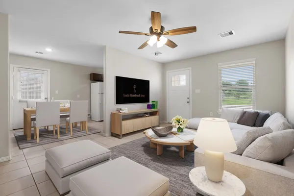 a living room with furniture and a flat screen tv