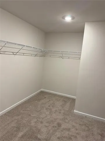 a kitchen with stainless steel appliances granite countertop a sink a stove and a wooden floor