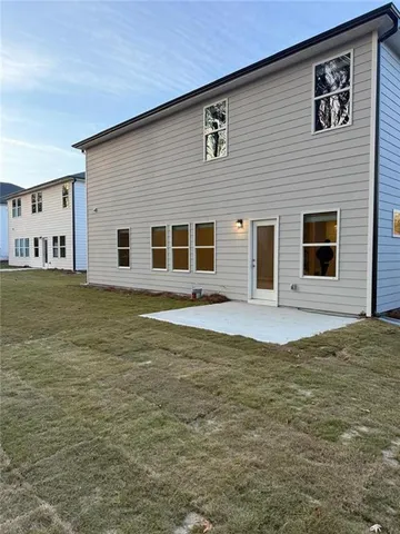 a view of a white house with a yard