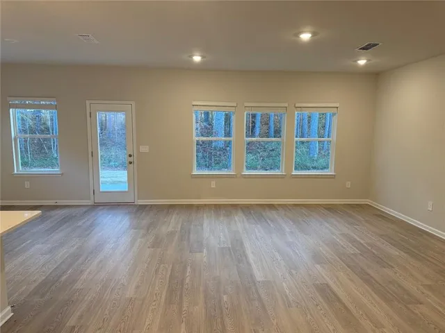 a kitchen with granite countertop a sink a stove and cabinets