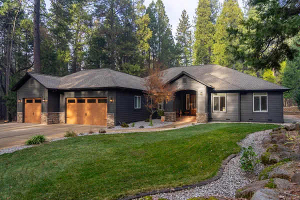 a front view of a house with a garden and patio