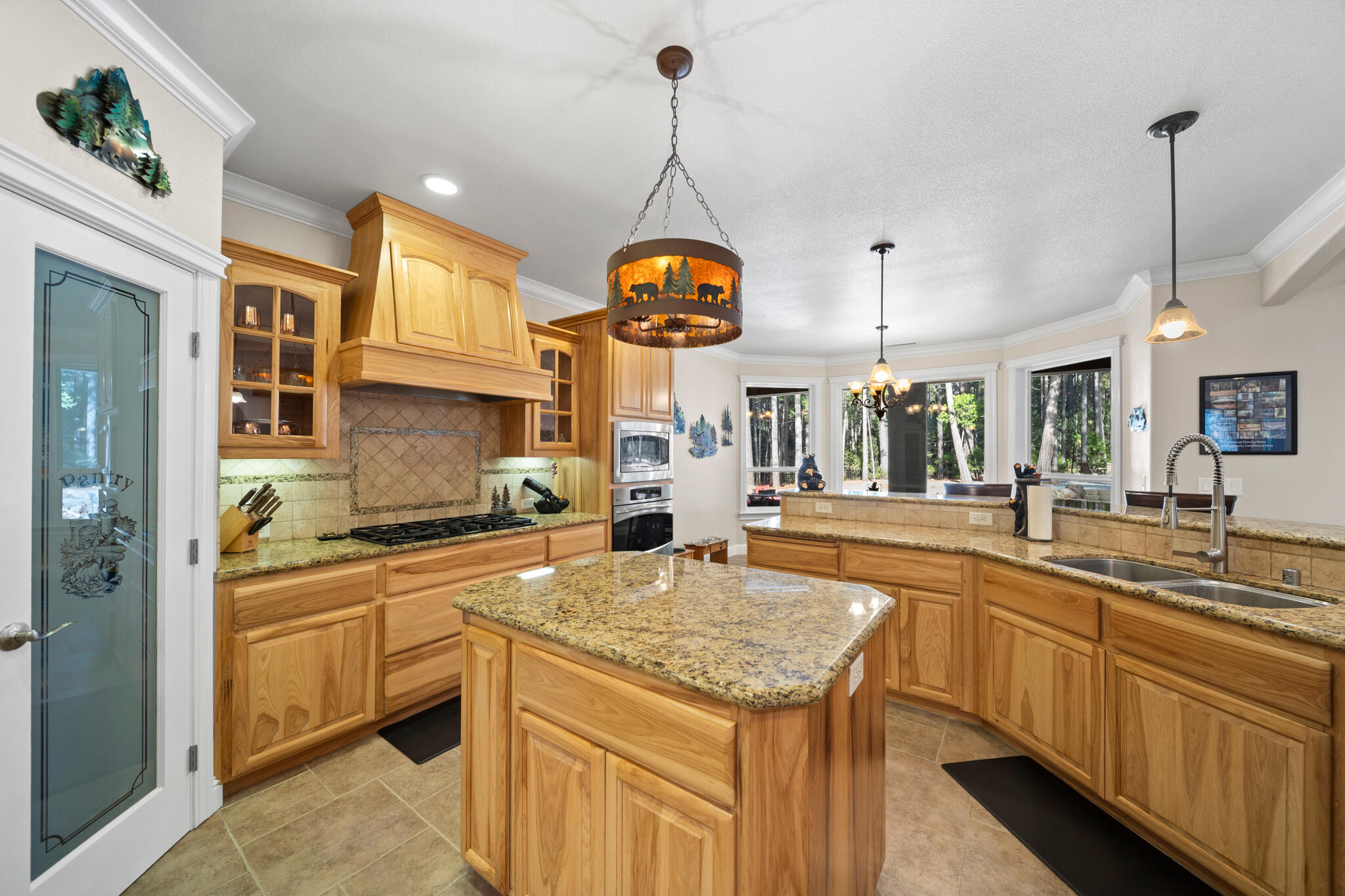 7795 Eastmoore Road Shingletown, CA 96088 - Photo 12 of 61 a kitchen with stainless steel appliances granite countertop a sink a stove and a wooden floors
