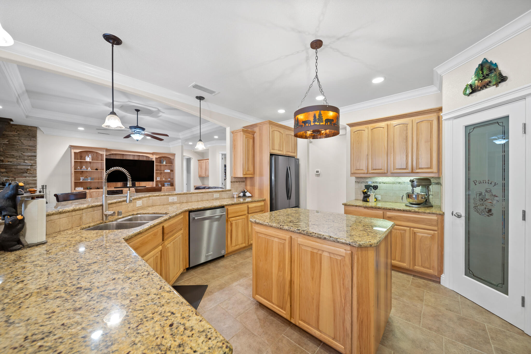 7795 Eastmoore Road Shingletown, CA 96088 - Photo 13 of 61 a kitchen with kitchen island granite countertop a stove a sink a refrigerator and a wooden floor