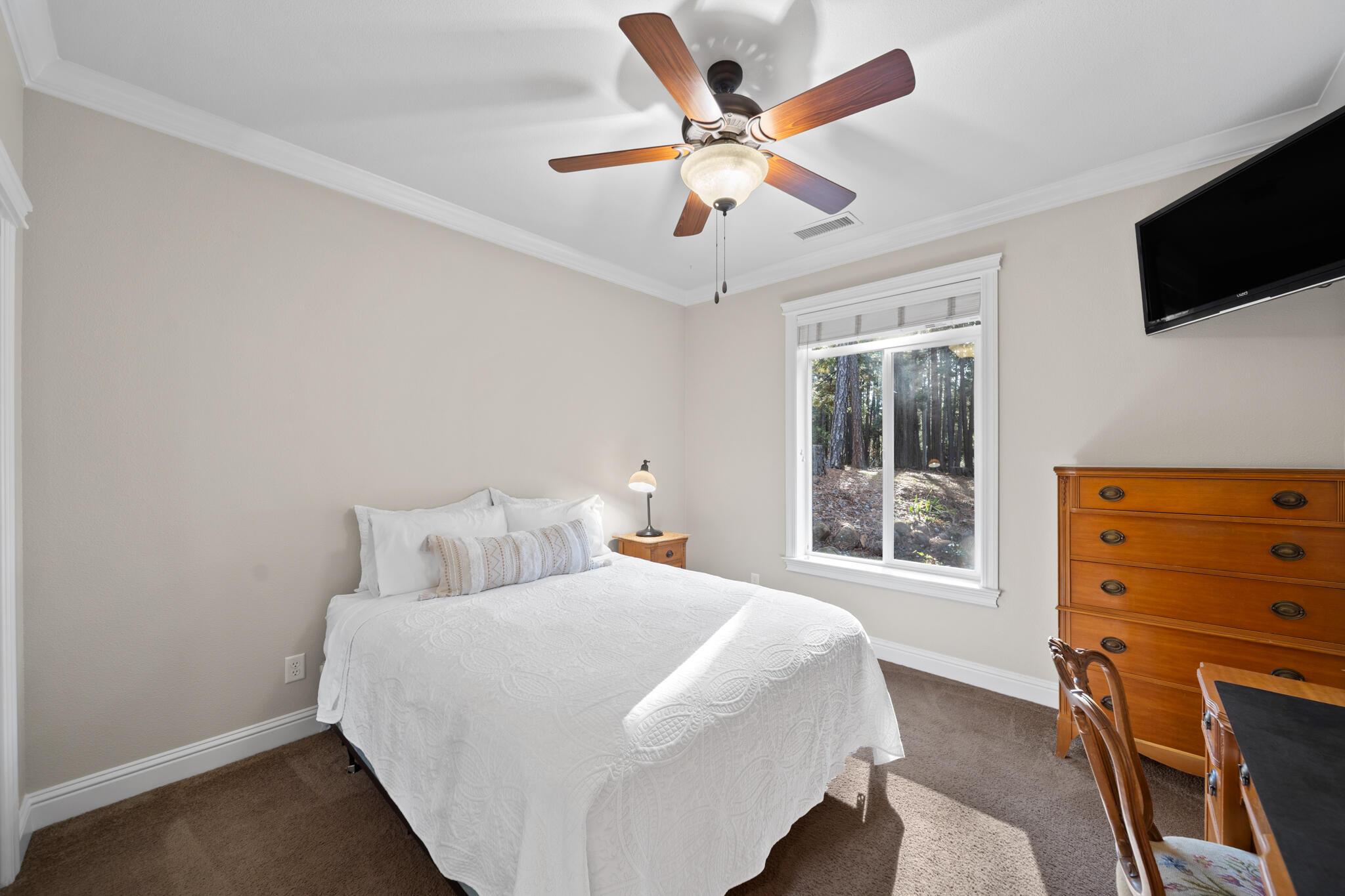 7795 Eastmoore Road Shingletown, CA 96088 - Photo 24 of 61 a bedroom with a bed and a flat tv screen on dresser